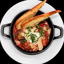 Baked Meatballs in a cast iron skillet with marinara, whipped ricotta, basil, and garlic toast at BLVD Grille