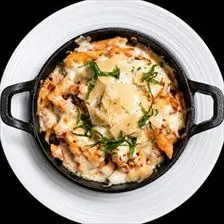 Baked Penne with marinara and melted mozzarella in a cast iron skillet at BLVD Grille
