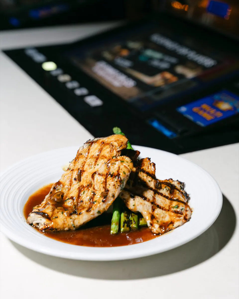Grilled Chicken Marsala served on the bar next to a bartop video poker machine at BLVD Grille, Henderson, NV