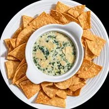 Spinach and Artichoke Dip with shaved parmesan and tortilla chips at BLVD Grille
